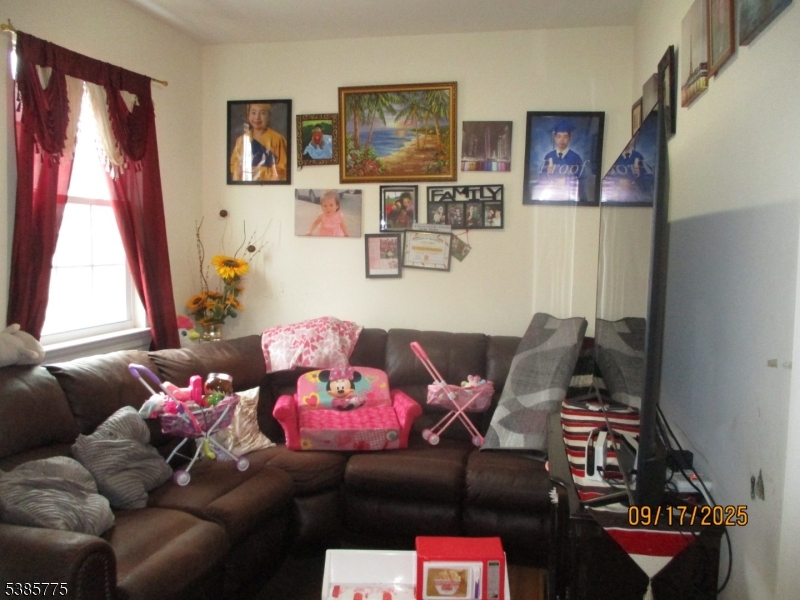 63 Warwick Street Newark, NJ 07105 - Photo 4 of 17 a living room with furniture and a window