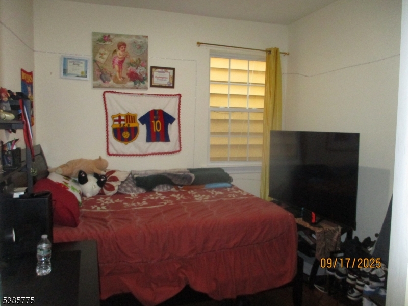 63 Warwick Street Newark, NJ 07105 - Photo 5 of 17 a bed sitting in a bedroom next to a window