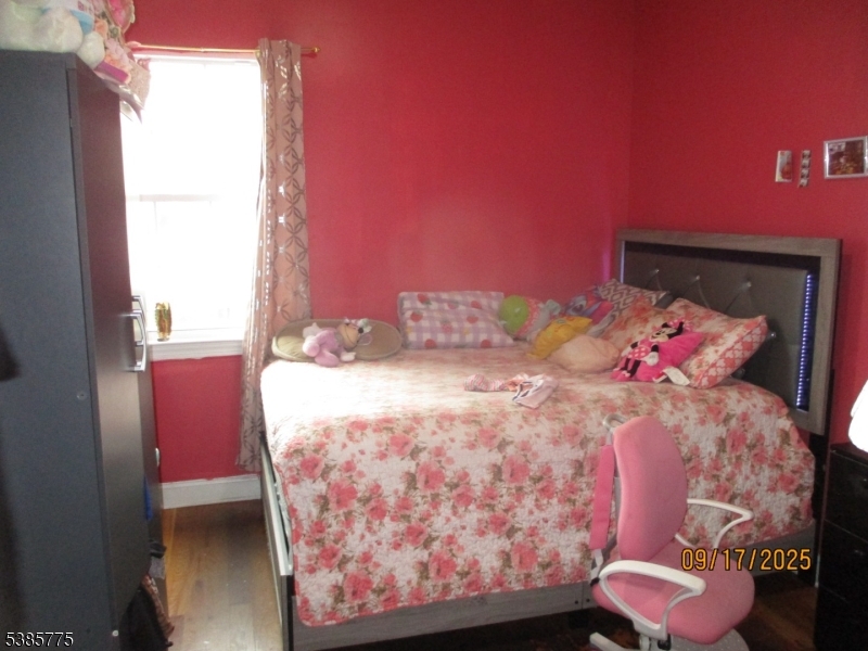 63 Warwick Street Newark, NJ 07105 - Photo 6 of 17 a bedroom with a bed and a window