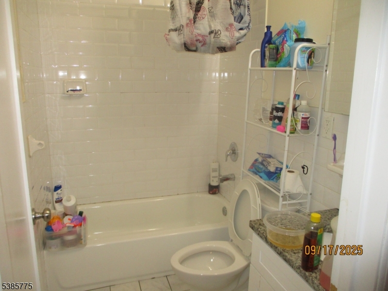 63 Warwick Street Newark, NJ 07105 - Photo 7 of 17 a bathroom with a sink mirror toilet and bathtub