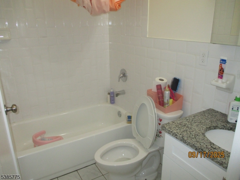 63 Warwick Street Newark, NJ 07105 - Photo 8 of 17 a bathroom with a granite countertop sink a toilet and bathtub