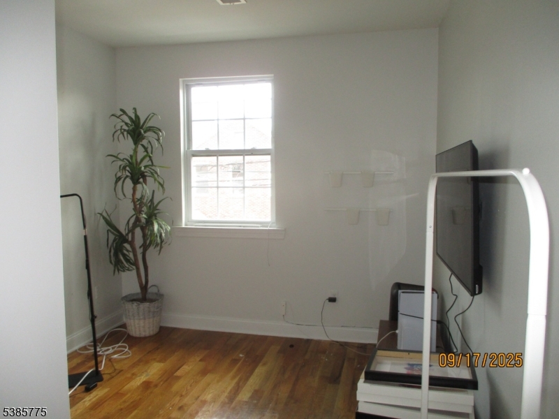 63 Warwick Street Newark, NJ 07105 - Photo 10 of 17 a view of room with wooden floor and potted plant