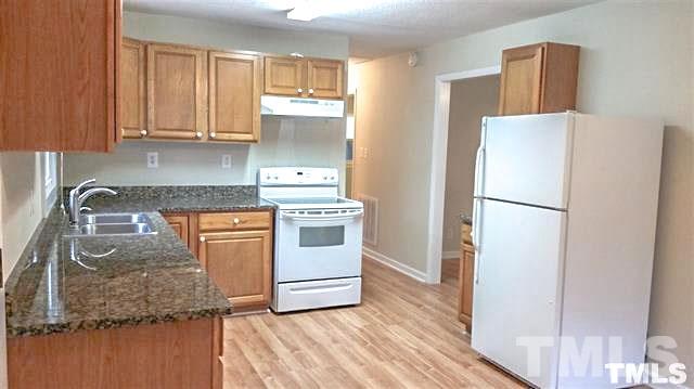 3026 Hamlin Road Durham, NC 27704 - Photo 6 of 15 The open kitchen has room for a table, and features beautiful oak cabinets in a warm honey finish with elegant dark granite counter tops and updated appliances.