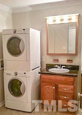 3026 Hamlin Road Durham, NC 27704 - Photo 9 of 15 The comfortably-sized bathroom accommodates a vanity, shower and full-size stacked Washer & Dryer and still has enough room for additional storage.