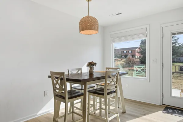 a view of a dining room with furniture and window