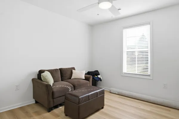 a bedroom with a bed a dresser and a window