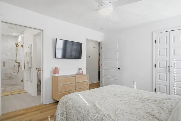 a view of walk in closet with clothes