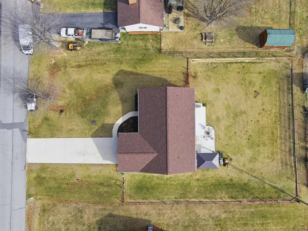 a patio with table and chairs and potted plants
