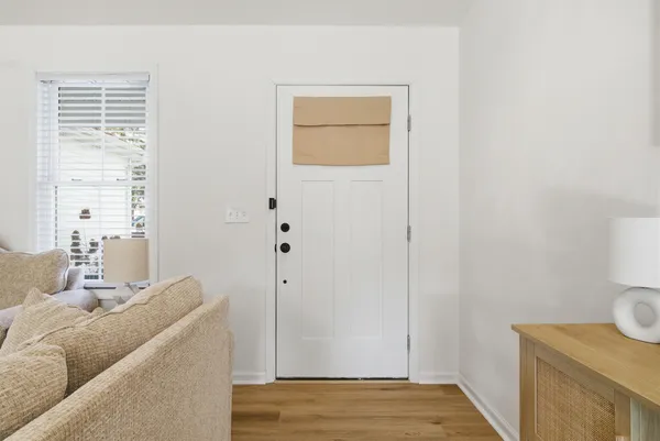 a view of room with furniture and wooden floor
