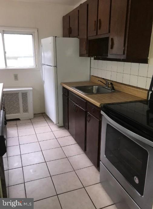 1267 Glassboro Road Williamstown, NJ 08094 - Photo 3 of 8 a kitchen with washing machine and cabinets