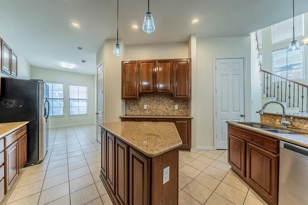 a kitchen with stainless steel appliances granite countertop a sink and cabinets