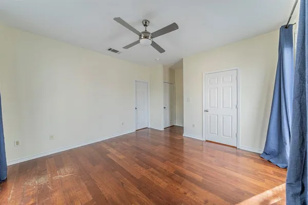 a view of a livingroom with a ceiling fan and wooden floor