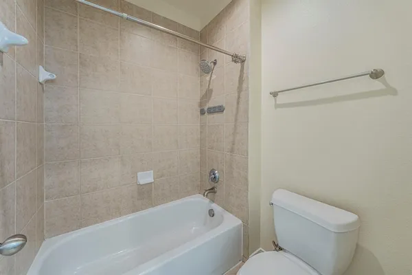 a bathroom with a toilet and a bathtub