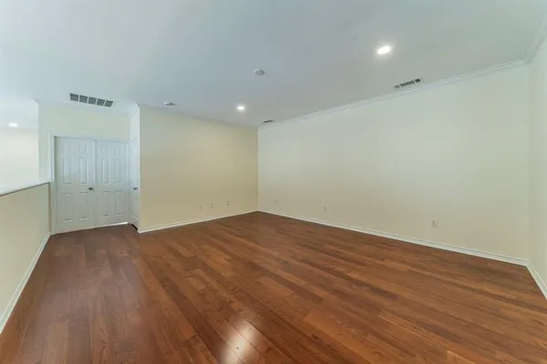 an empty room with wooden floor