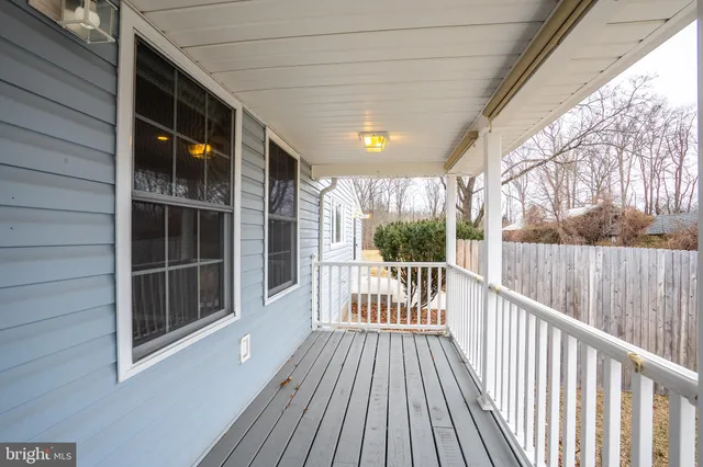 a view of a balcony with wooden floor and fence