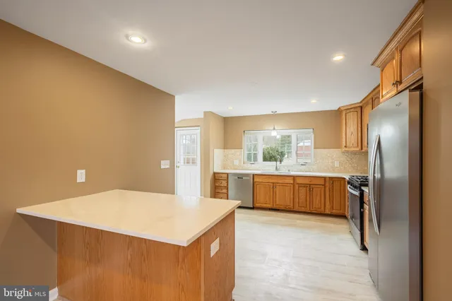 a kitchen with a refrigerator and a stove