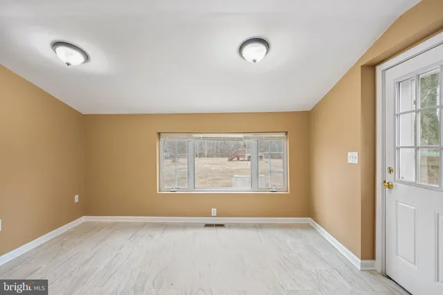 an empty room with a empty space and windows