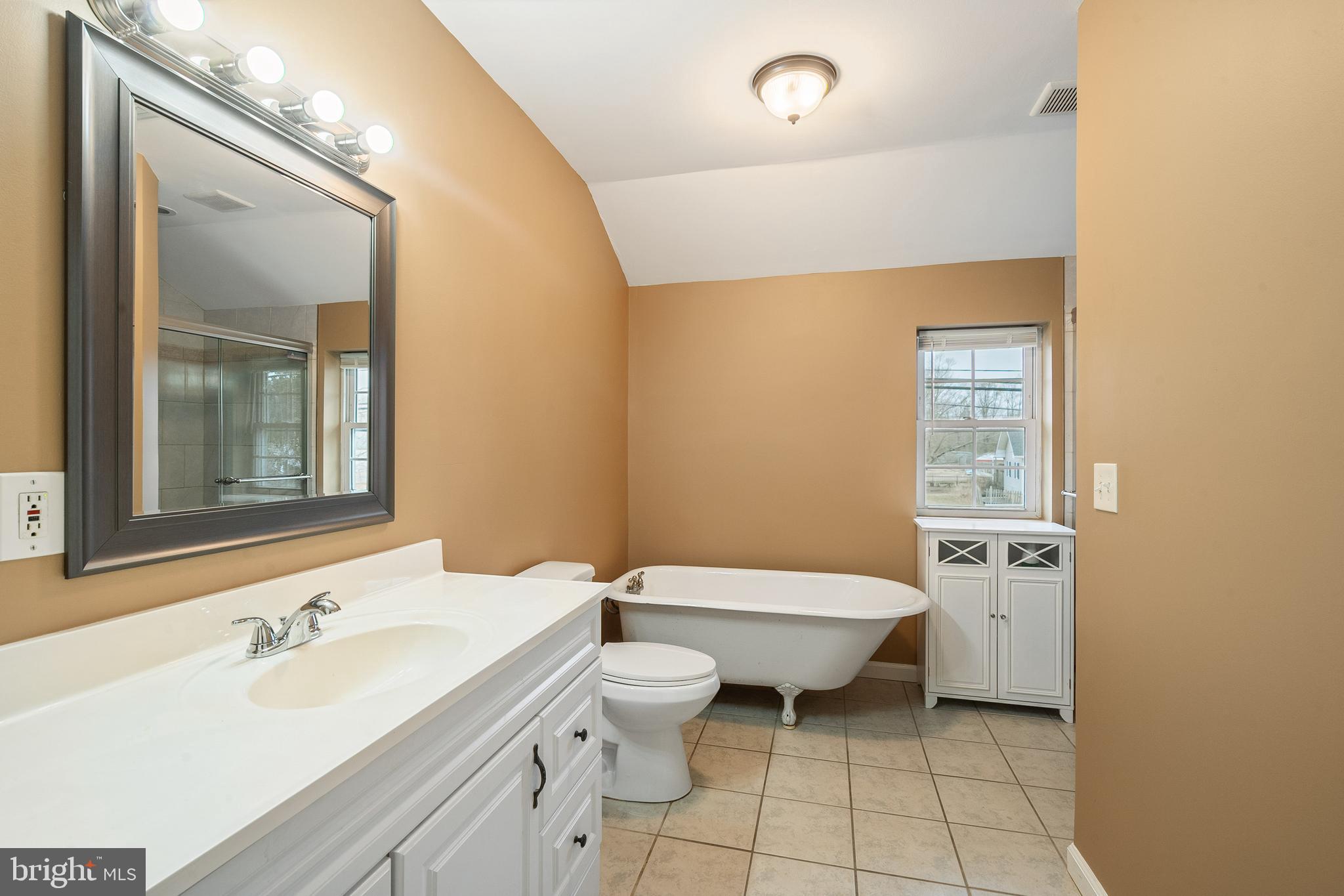266 Bakers Basin Road Lawrence Township, NJ 08648 - Photo 26 of 32 a bathroom with a sink toilet and mirror