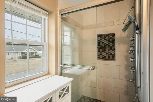 a bathroom with a shower and a sink