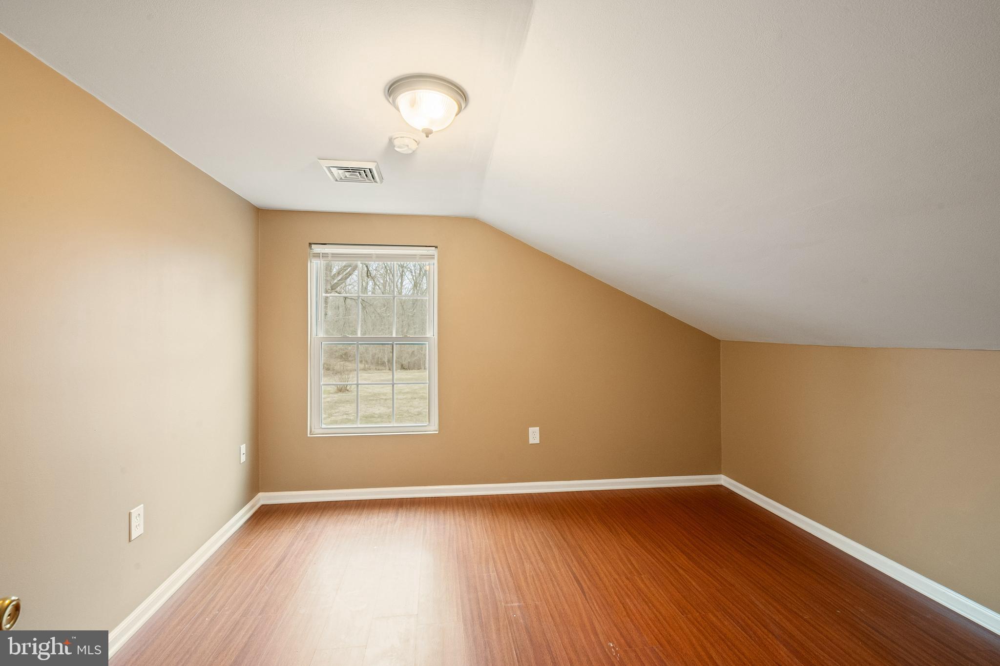 266 Bakers Basin Road Lawrence Township, NJ 08648 - Photo 29 of 32 an empty room with wooden floor and windows