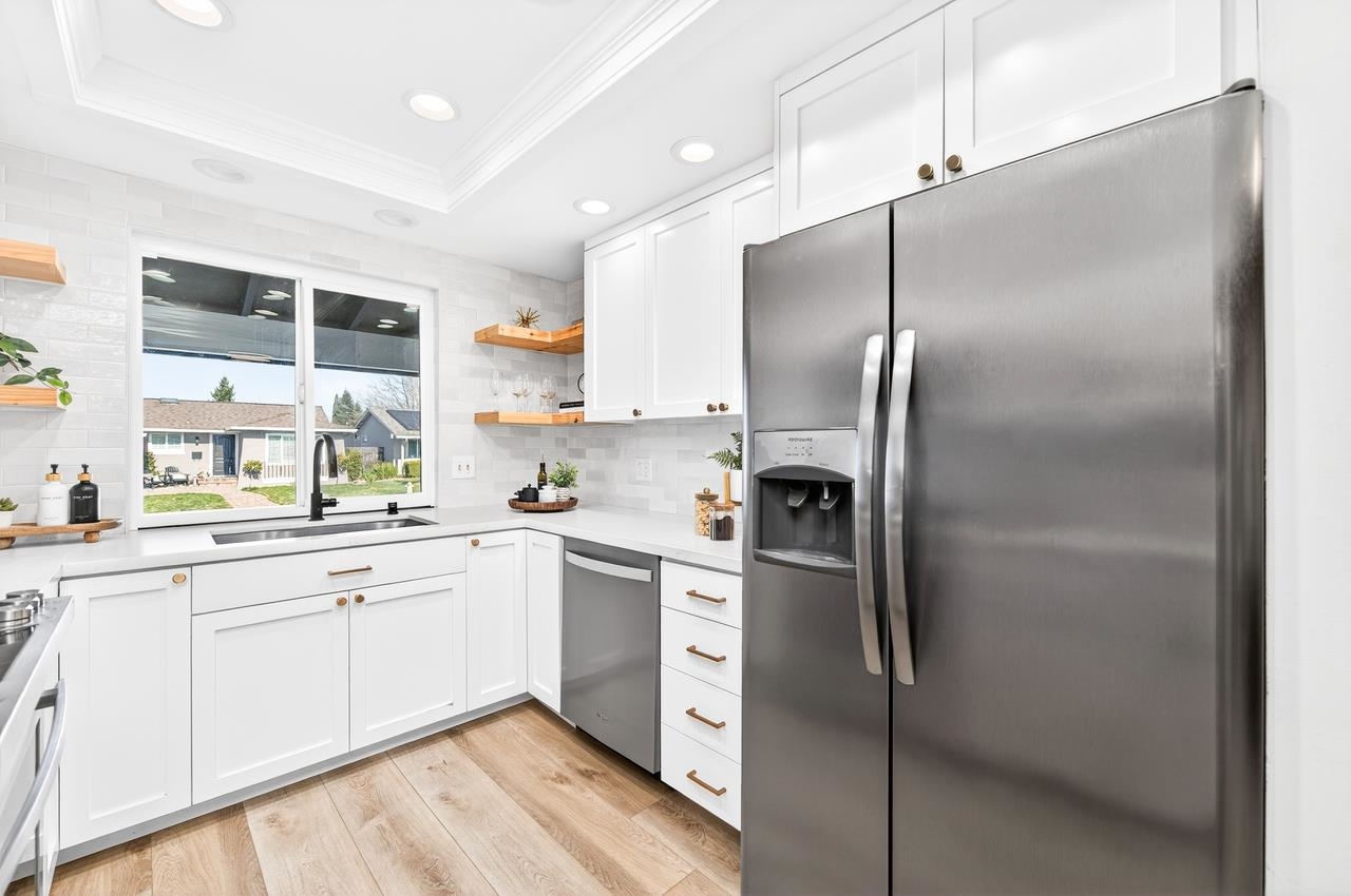 6762 Rancho Court Pleasanton, CA 94588 - Photo 14 of 42 a kitchen with stainless steel appliances cabinets a sink and a window