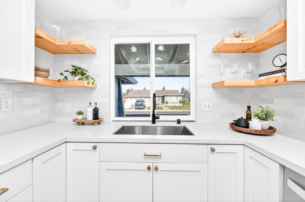 6762 Rancho Court Pleasanton, CA 94588 - Photo 15 of 42 a kitchen with stainless steel appliances white cabinets and a window
