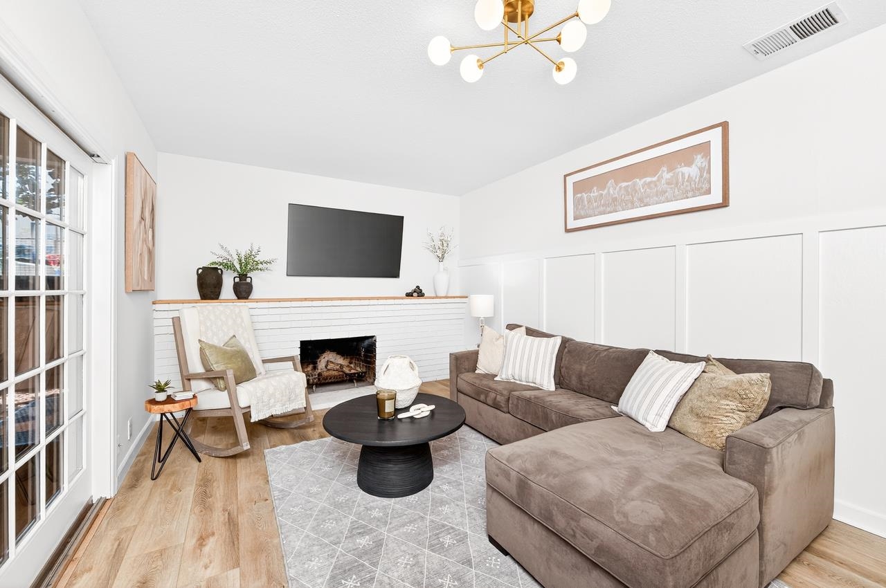 6762 Rancho Court Pleasanton, CA 94588 - Photo 19 of 42 a living room with furniture a fireplace and a flat screen tv