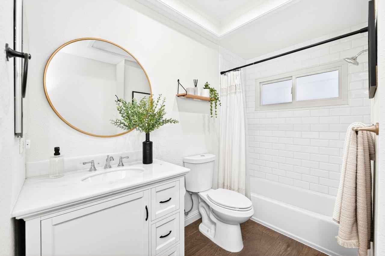 6762 Rancho Court Pleasanton, CA 94588 - Photo 22 of 42 a bathroom with a sink a toilet and a mirror