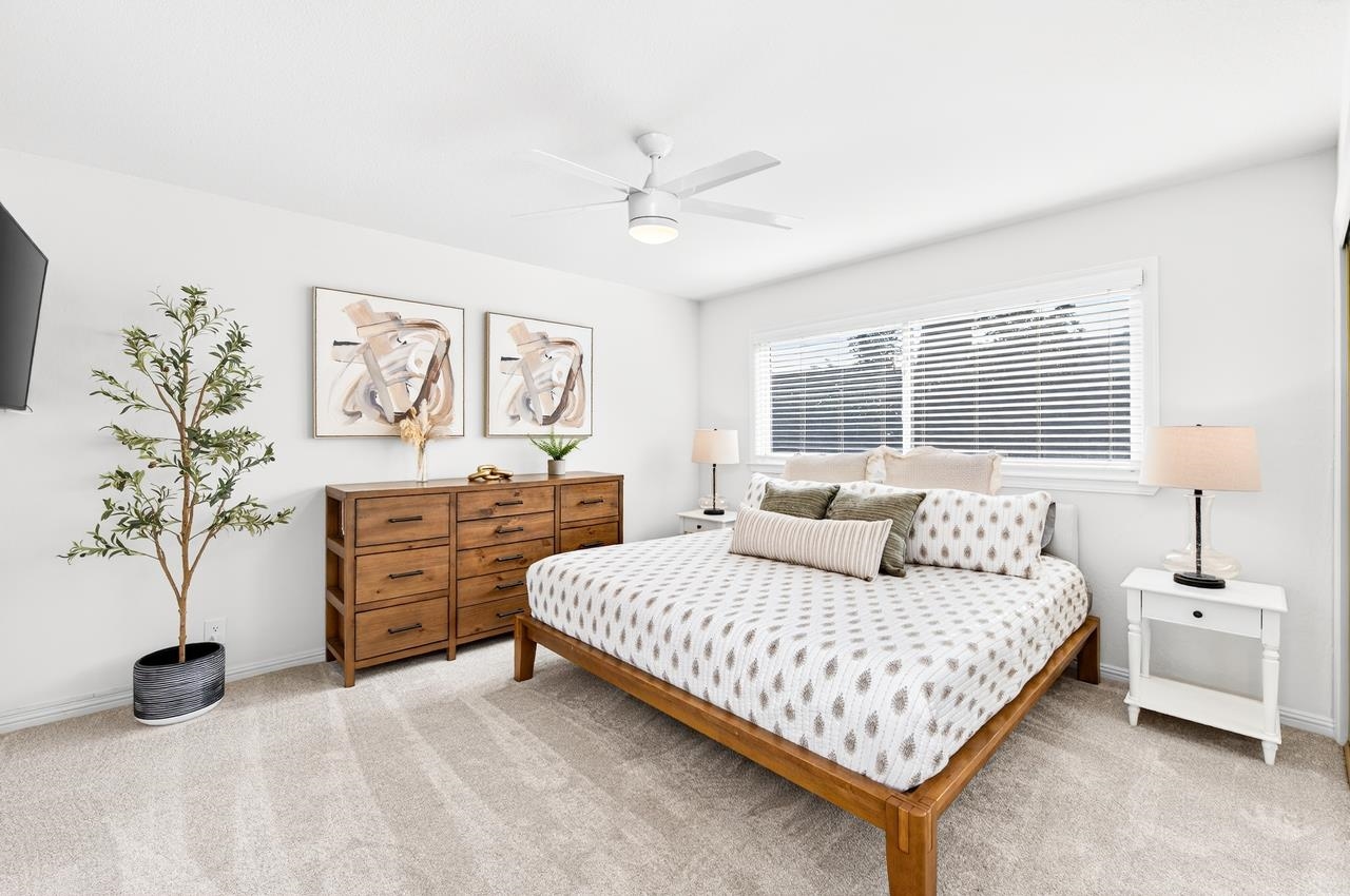 6762 Rancho Court Pleasanton, CA 94588 - Photo 23 of 42 a bedroom with a bed and a chandelier