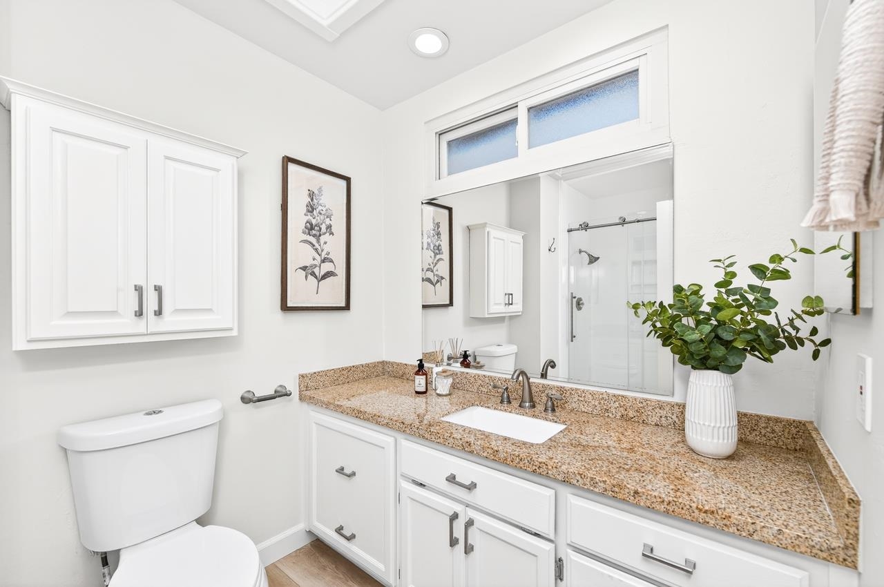 6762 Rancho Court Pleasanton, CA 94588 - Photo 25 of 42 a bathroom with a granite countertop sink and a toilet