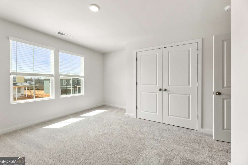 5420 Aurora Trail Flowery Branch, GA 30542 - Photo 18 of 38 a view of an empty room with a window