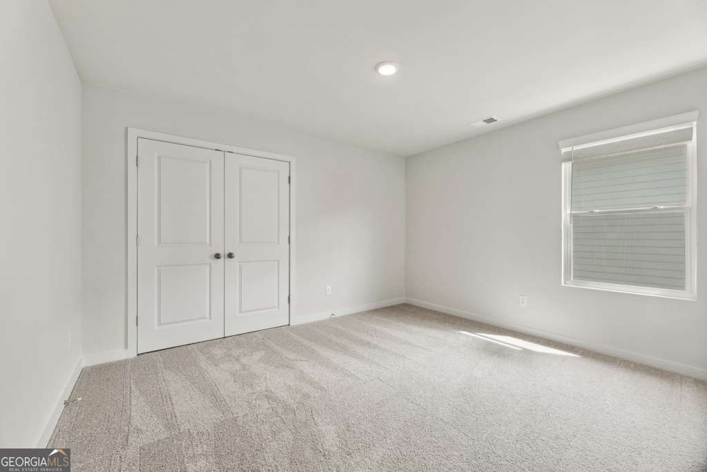 5420 Aurora Trail Flowery Branch, GA 30542 - Photo 19 of 38 a view of an empty room with a window