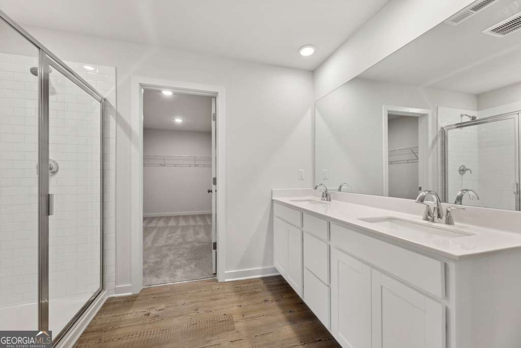 5420 Aurora Trail Flowery Branch, GA 30542 - Photo 26 of 38 a bathroom with a double vanity sink mirror and shower