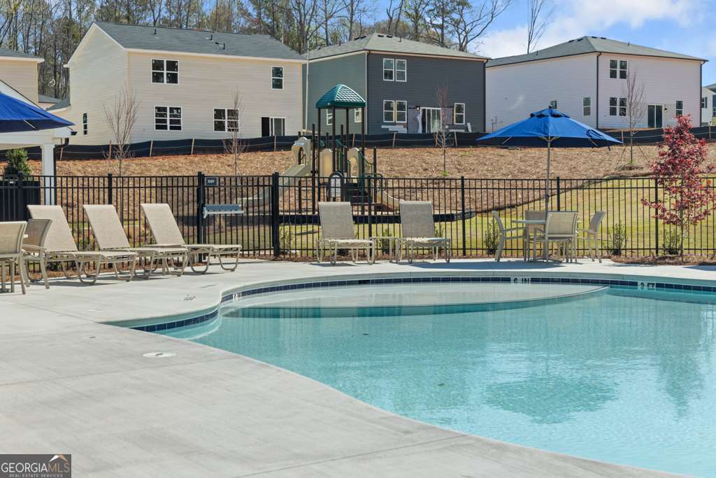 5420 Aurora Trail Flowery Branch, GA 30542 - Photo 29 of 38 a swimming pool with outdoor seating and yard