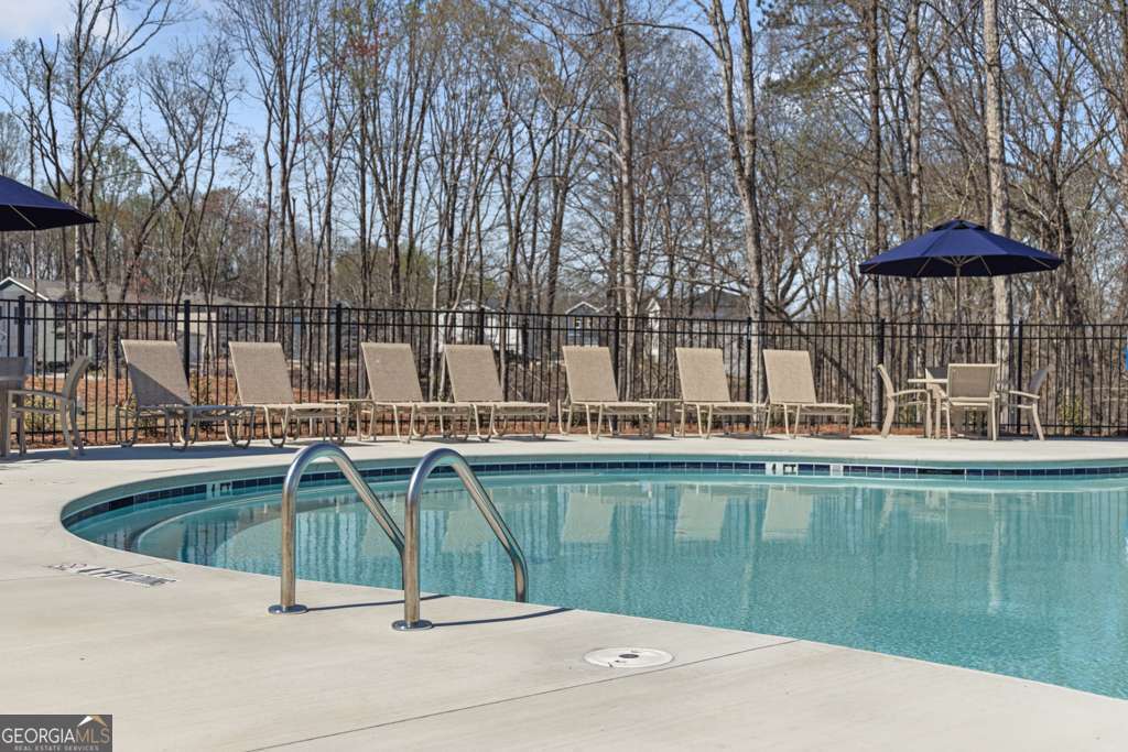 5420 Aurora Trail Flowery Branch, GA 30542 - Photo 32 of 38 a swimming pool with outdoor seating and yard