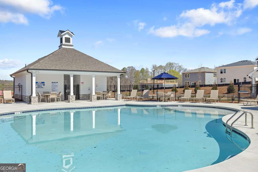 5420 Aurora Trail Flowery Branch, GA 30542 - Photo 34 of 38 a view of a house with pool and chairs