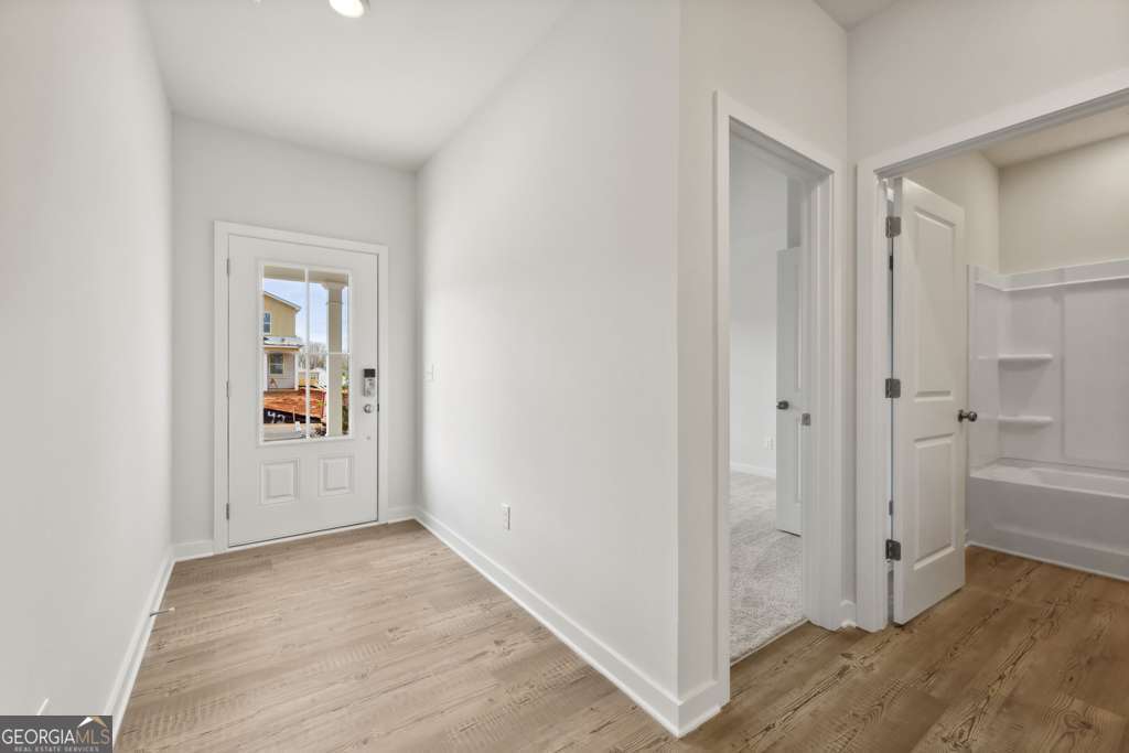 5420 Aurora Trail Flowery Branch, GA 30542 - Photo 4 of 38 a view of a hallway with wooden floor and closet area