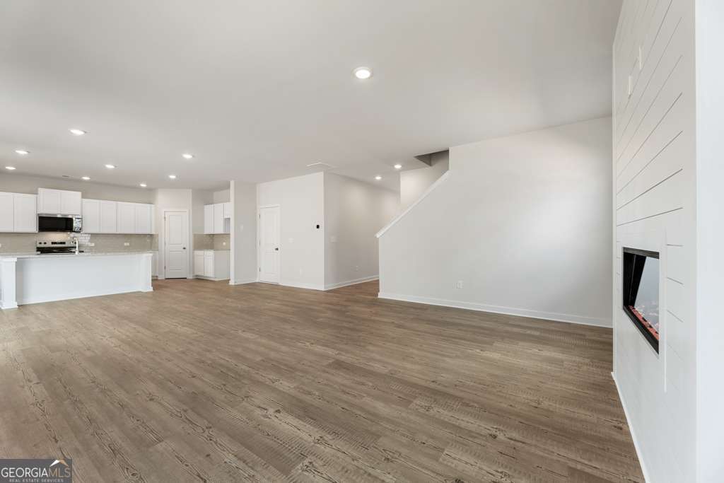 5420 Aurora Trail Flowery Branch, GA 30542 - Photo 10 of 38 a view of a kitchen with a sink and a refrigerator