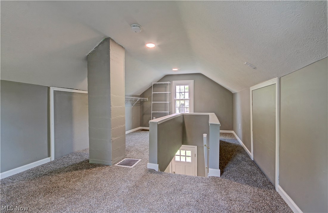 14507 Glencliffe Road Cleveland, OH 44111 - Photo 25 of 31 Bonus room with a textured ceiling, vaulted ceiling, and dark carpet