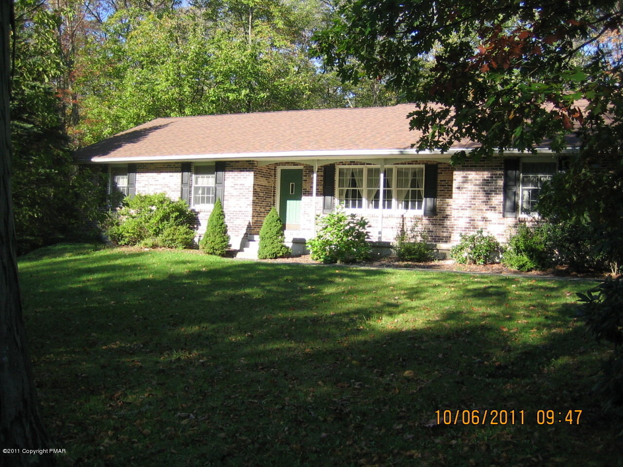 183 Koerners Road Cresco, PA 18326 - Photo 1 of 28 a front view of a house with a garden