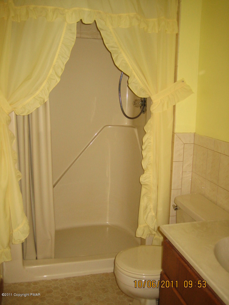 183 Koerners Road Cresco, PA 18326 - Photo 17 of 28 a bathroom with a toilet and a shower
