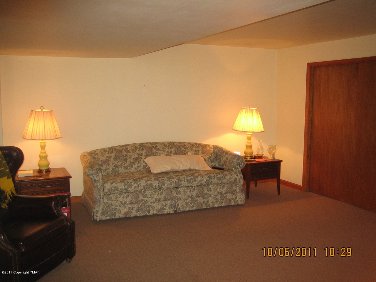 183 Koerners Road Cresco, PA 18326 - Photo 19 of 28 a bedroom with a bed and a lamp on table