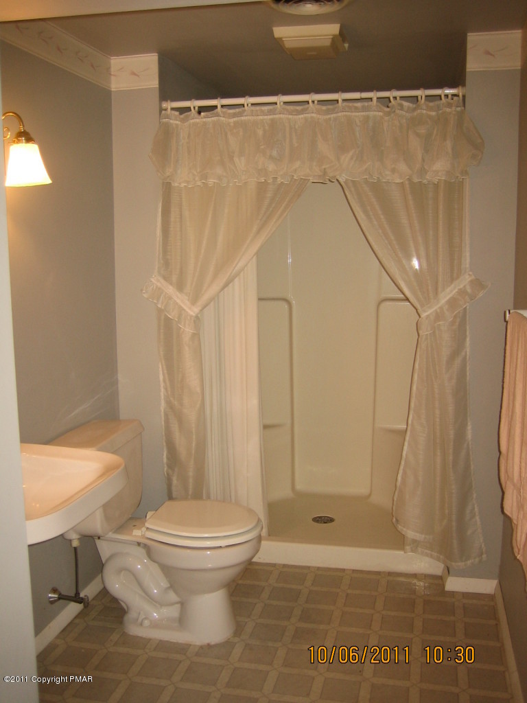 183 Koerners Road Cresco, PA 18326 - Photo 20 of 28 a bathroom with a toilet and a shower