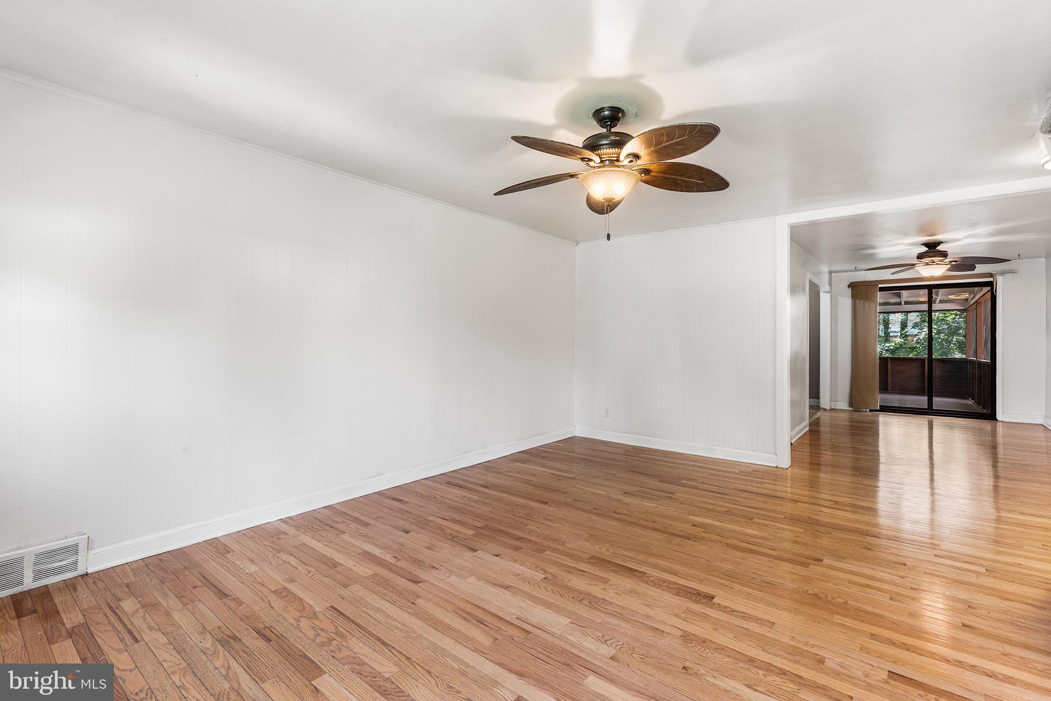 390 Glen Cove Road Collingdale, PA 19023 - Photo 6 of 27 a view of an empty room with window and wooden floor