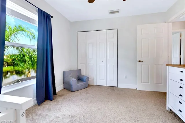 a spacious bedroom with a bed and a window