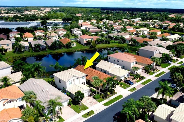 an aerial view of a house with a swimming pool yard and outdoor seating