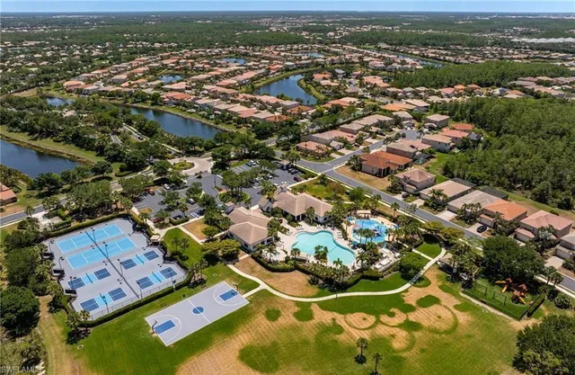 an aerial view of a house with a garden and lake view