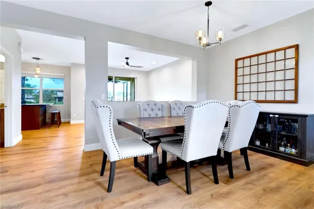 a view of a a dining room with furniture window and wooden floor