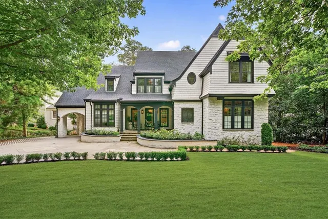 a front view of a house with a garden