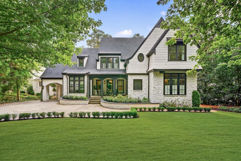 a front view of a house with a garden